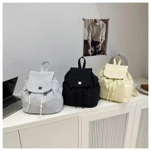 Detailed comparison of plaid and solid minimalist drawstring backpacks with side pockets