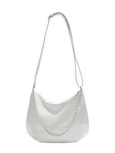 Minimalist beige half-moon crossbody bag for women with decorative silver chain link