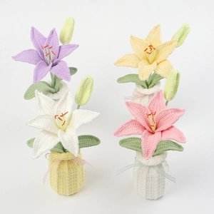 Detailed knit crochet lily flowers in vases showing intricate texture and pastel colors