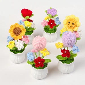 Macro shot of assorted handmade crochet mini potted sunflowers and colorful floral decor
