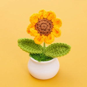 Macro shot showing detailed crochet texture of a handmade sunflower potted plant ornament