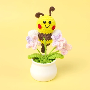 Handmade crochet potted plant featuring a cute bee and pink flowers with pearl details