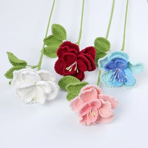 Detailed knit texture of handmade crochet roses in white, red, blue, and pink colors