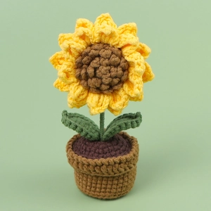 Handmade crochet sunflower car ornament in a brown knitted pot with green leaves