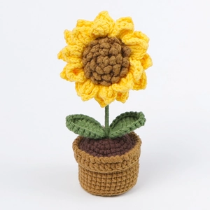 Detailed close-up of handmade crochet sunflower plant in a pot for car decoration