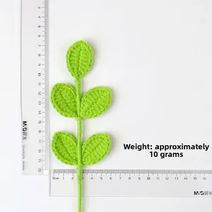 Detail shot of a 10g handmade crochet green leaf sprig with visible sizing scale