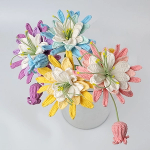 Detailed view of hand-knitted purple and white crochet flowers in a glass vase
