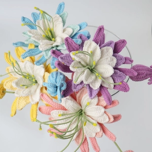 Detailed macro view of multi-colored handmade crochet lily flowers with yarn texture