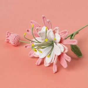 Close-up of handmade crochet Epiphyllum flower with pink petals and knit leaf