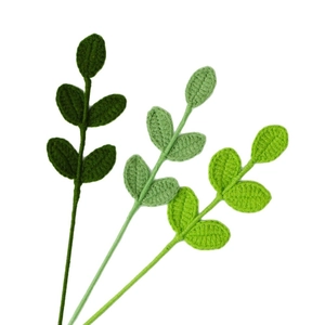 Handcrafted crochet green leaves set with detailed knitted texture on a white background