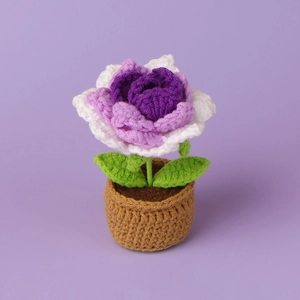 Close-up of handmade crochet sunflower plant with purple gradient petals and brown pot