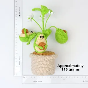 Detail shot of a handmade crochet avocado potted plant with size ruler and 115g weight