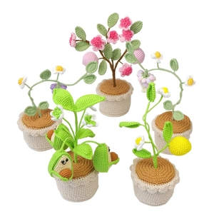 Handmade crochet potted fruit plants featuring avocado and peach on a white background