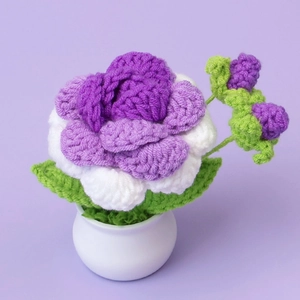 Handmade crochet purple floral plant in white ceramic pot for home decoration