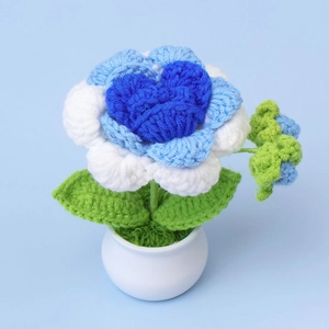 Handmade crochet blue flower potted plant in white ceramic pot for home decoration