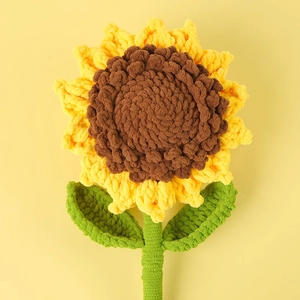 Handmade crochet sunflower decoration made with soft chunky yellow and green yarn