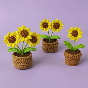 Cute handmade crochet sunflower potted plants in three sizes on a soft purple background