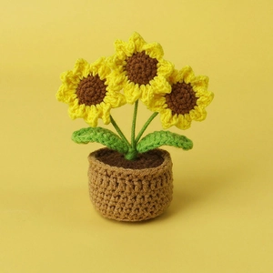 Handmade crochet sunflower potted plant with yellow petals and brown basket base