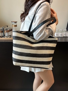 Grande borsa tote in paglia intrecciata a righe bianche e nere con manici in ecopelle nera