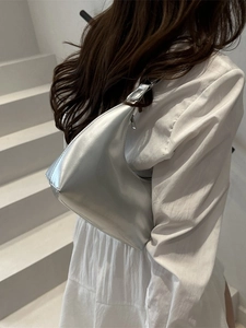 Silver patent leather crescent shoulder bag with metallic finish for women in minimalist style