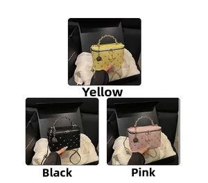 Mini quilted box bags in yellow, black, and pink with chain handles and rivet details