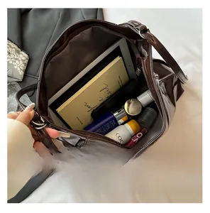 Spacious interior of brown patent leather tote bag showing storage capacity for essentials