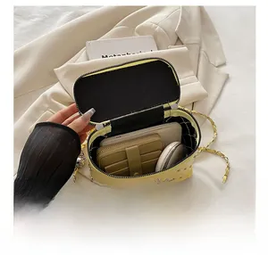 Internal storage display of quilted diamond chain bag showing phone and wallet