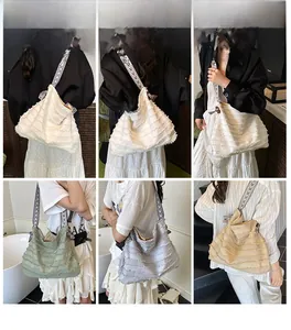 Détail d'un grand sac cabas en toile avec bords effilochés et bandoulière bohème colorée