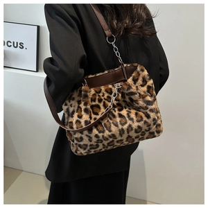 Detail of leopard print faux fur handbag with brown leather strap and metal chain links