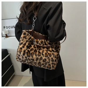 Macro detail of plush leopard print tote bag with leather strap and silver metal rings