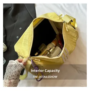 Top view of bright yellow Oxford bag showing large internal capacity with iPad and makeup