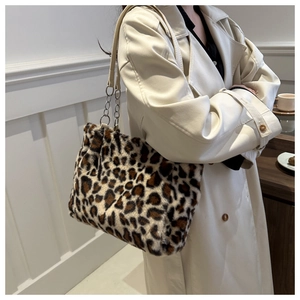 Close-up of leopard print plush tote bag with faux fur texture and metal chain strap