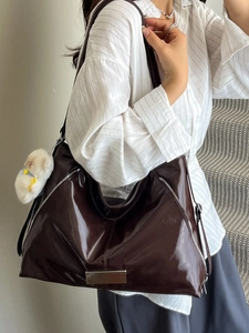 Retro dark brown patent leather tote bag with glossy finish and white plush charm accessory