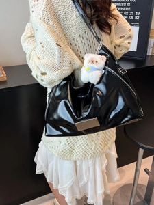Chic black glossy tote bag for women with silver zippers and cute white bear keychain charm