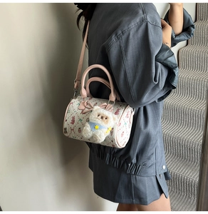 Pink Boston bag with cartoon bear prints and cute plush bear charm on shoulder strap
