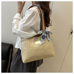 Detail of summer woven tote bag with brown leather straps and vintage print scarf accent