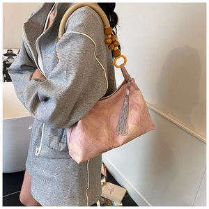 Pink floral hobo bag with unique wooden bead woven strap and gray silk tassel detail