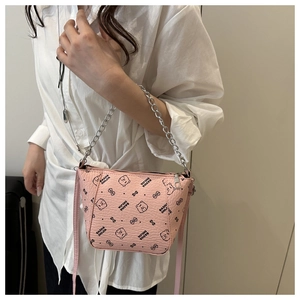 Detail of pink bucket bag with bear print and dual silver chain and leather straps
