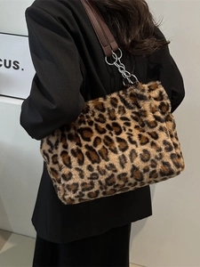 Fashionable leopard print faux fur tote bag with brown leather straps and metal chain detail