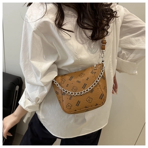 Detailed shot of a brown crossbody bucket bag with bear print and silver chain link