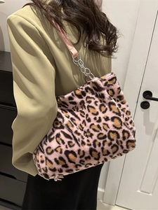Pink leopard print plush tote bag with silver chain strap shown on model's shoulder