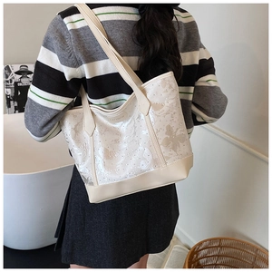 Detail of cream tote bag featuring elegant butterfly embroidery and sequin embellishments