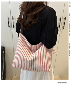 Detail of red and white striped cotton linen tote bag with comfortable white shoulder straps