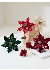 Detailed view of velvet Christmas poinsettia flowers with glitter edges and golden stamen