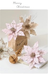 Pink Christmas velvet poinsettia flowers with glitter details on a holiday setting