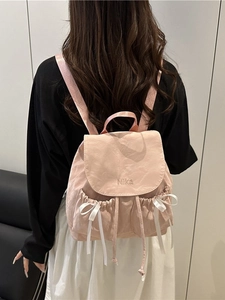 Pink lightweight nylon backpack for women with embroidered Nika text and white satin bow