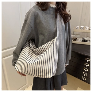 Détail du grand sac cabas en toile avec motif classique à rayures verticales bleu et blanc