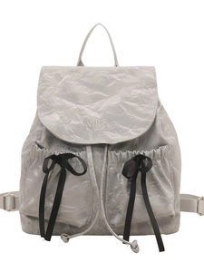Chic silver pleated backpack with Nika embroidery and decorative black ribbon bows