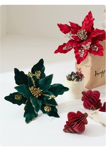 Velvet Poinsettia flower decorations with gold glitter and red paper fans for Christmas