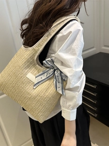 Summer straw tote bag with ribbon bow and woven texture for beach vacation style